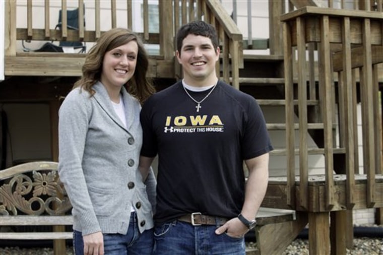 High school sweethearts Anthony Laubenthal and Ashley Weller stand outside their new home in Norwalk, Iowa. They hadn't given much thought to buying a place until Ashley's dad mentioned the $8,000 tax credit available to first-time homebuyers.